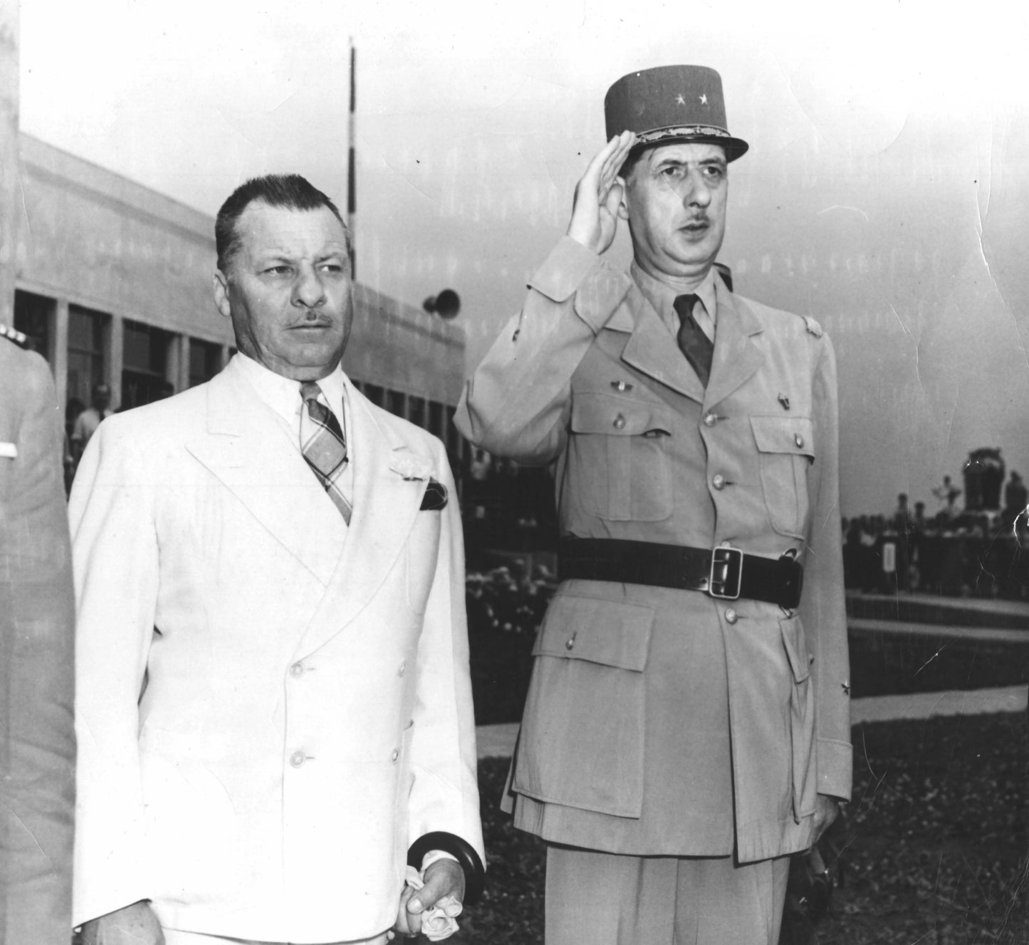 Maire Adhémar Raynaud et le général de Gaulle saluant les militaires à l'aéroport