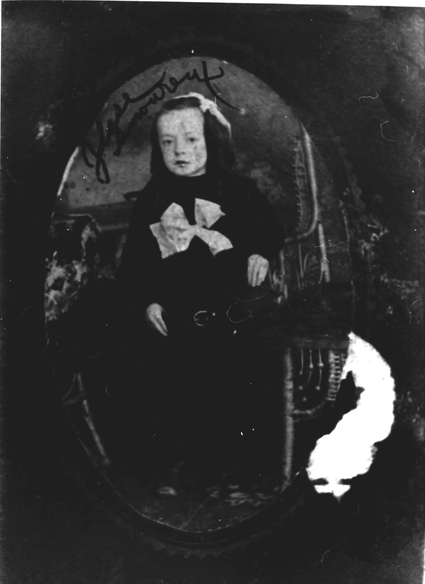 Jeune fille près d'une chaise en rotin